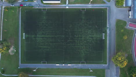 People-playing-soccer-football-aerial-top-view-green-grass-France-sports